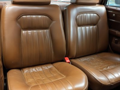 Before: Vintage car leather seats with cracks and damage