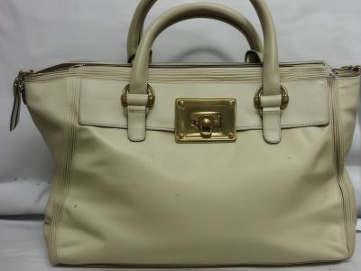 Before: Designer handbag with water damage and worn hardware