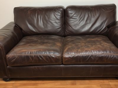 Before: Modern leather sofa looking dull and worn